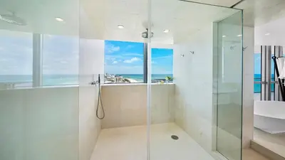 a bathroom with a shower and a sink and a window at Oceanfront Private Penthouse Condo at The Setai -3909 in Miami Beach