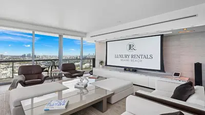 a living room with a large screen in a building at Oceanfront Private Penthouse Condo at The Setai -3909 in Miami Beach