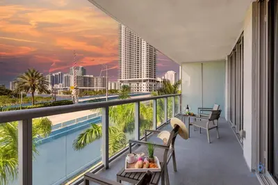 a balcony with a view of the city at Pool Apartment with Balcony, Near Beach in Hallandale Beach