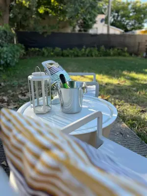 a white picnic table with a bottle of wine on it at Stylish Studio Near Wynwood & Design District in Miami