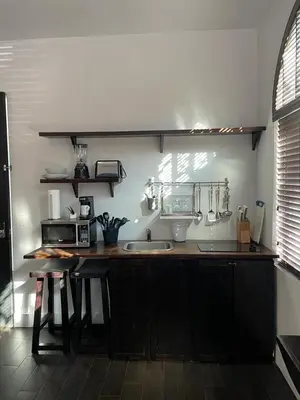 a kitchen with a counter with a sink and a microwave at Vive Zen 2 Queen Beds in Miami