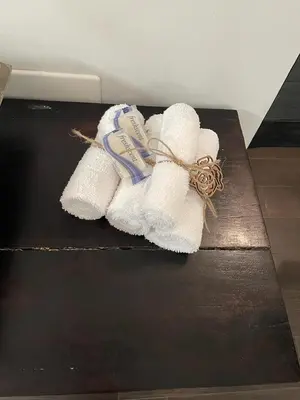 a pile of towels sitting on top of a table at Vive Zen 2 Queen Beds in Miami