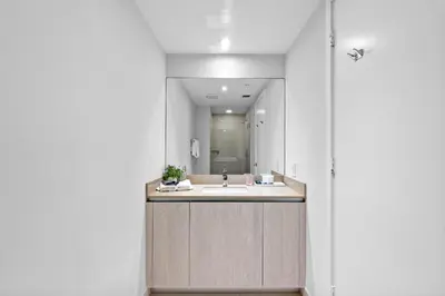 a bathroom with a sink and a mirror at Picturesque Beachfront Condo - LOVELY 2BD and 2BA APT WITH DIRECT OCEAN VIEW in Hollywood