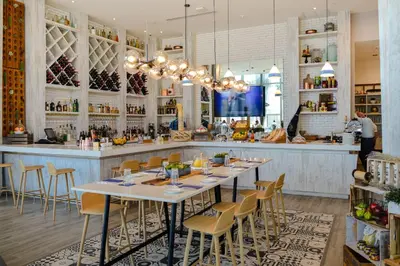 a restaurant with a long table and a bar at Iconic Ocean View - in this Stunning Condo in Hollywood
