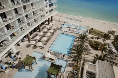 an aerial view of a hotel with a pool and a beach at Iconic Ocean View - in this Stunning Condo in Hollywood