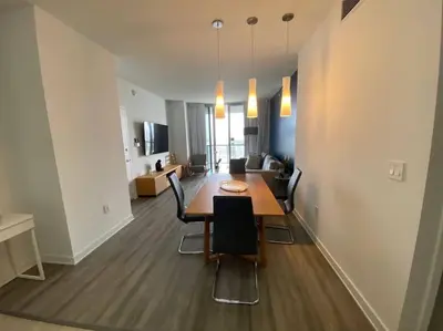 a living room with a dining room table and chairs at Dream Beach Apt 1BR Kitchen & Pool Access 06A in Hallandale Beach