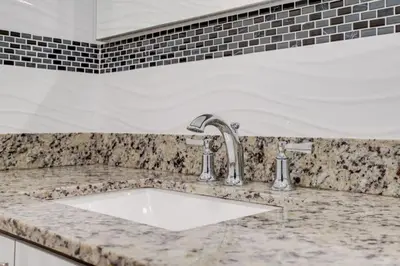 a white sink in a marble counter top in a kitchen at Hollywood Home w Pool Jacuzzi BBQ and Pool Table in Hollywood