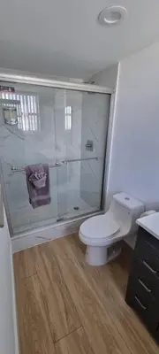 a bathroom with a toilet and a glass wall at NEW LUXURY APARTMENT 2Br 2Ba DIRECT BEACH ACCESS in Hollywood Beach