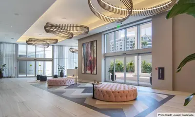 a large lobby with large windows and pink ottoman at Lux apartment Hyde Beach House in Hollywood