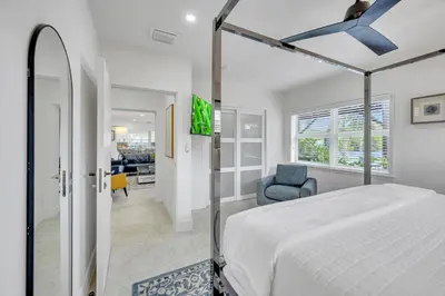 a bedroom with a bed and a blue chair at 180 of Waterfront Heated Pool Walk To Beach Paradise Point Key RESIDENCES in Fort Lauderdale
