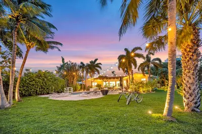 a park with palm trees at night with lights at 180 of Waterfront Heated Pool Walk To Beach Paradise Point Key RESIDENCES in Fort Lauderdale