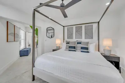 a white bedroom with a white bed and two lamps at 180 of Waterfront Heated Pool Walk To Beach Paradise Point Key RESIDENCES in Fort Lauderdale