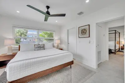 a white bedroom with a large bed and a window at 180 of Waterfront Heated Pool Walk To Beach Paradise Point Key RESIDENCES in Fort Lauderdale