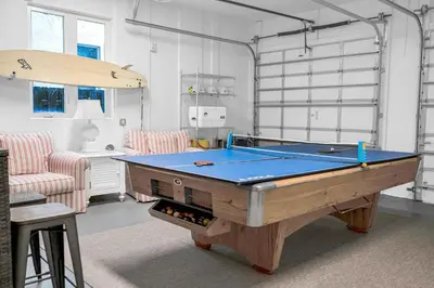 a ping pong table in a room with at Steps from the Beach Heated Pool Sun Key Game room RESlDENCES in Fort Lauderdale