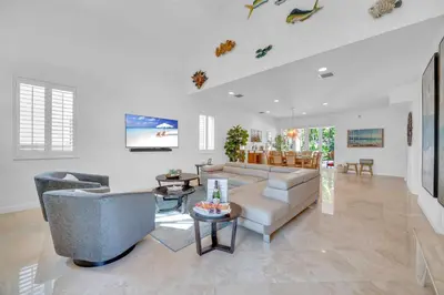 a living room with a couch and a table at Steps from the Beach Heated Pool Sun Key Game room RESlDENCES in Fort Lauderdale