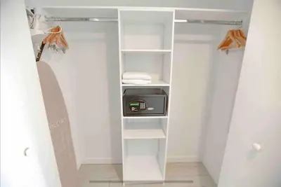 a closet with white shelves and a clock in it at Miami Beach 1 Bedroom w Pool 1109A in Hallandale Beach
