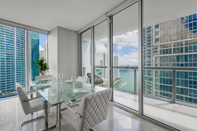 a dining room with a table and views of the city at Wonderful 2 BR Condo Icon Brickell With Pool in Miami