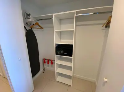 a white closet with a mirror in a room at Just Minutes from the Beach, 2 Full Bed Studio in Hallandale Beach
