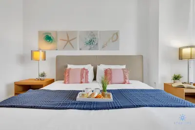 a bedroom with a bed with a tray of fruit on it at Modern Resort with Balcony - Pool - Gym in Hallandale Beach
