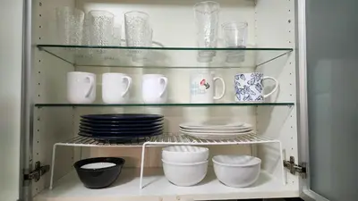 a cabinet filled with plates and cups and dishes at Bayfront Apartment Breathtaking Views- one bedroom w balcony- living room -Free Parking in Miami Beach