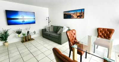a living room with a couch and a glass table at Bayfront Apartment Breathtaking Views- one bedroom w balcony- living room -Free Parking in Miami Beach