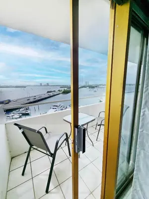 a balcony with a table and chairs and a view of the ocean at Bayfront Apartment Breathtaking Views- one bedroom w balcony- living room -Free Parking in Miami Beach