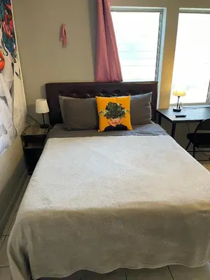 a bedroom with a large bed with yellow pillows at Best Value inside City Miami, Near Airport, Beach, Center & Metro in Miami
