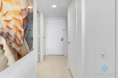a hallway with white walls and a white door at Pool - Apartment with Balcony - Gym - Near Beach in Hallandale Beach