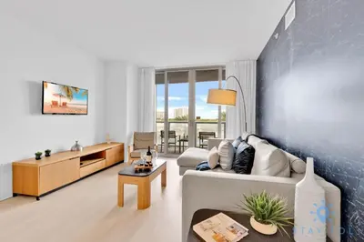 a living room with a couch and a table at Pool - Apartment with Balcony - Gym - Near Beach in Hallandale Beach